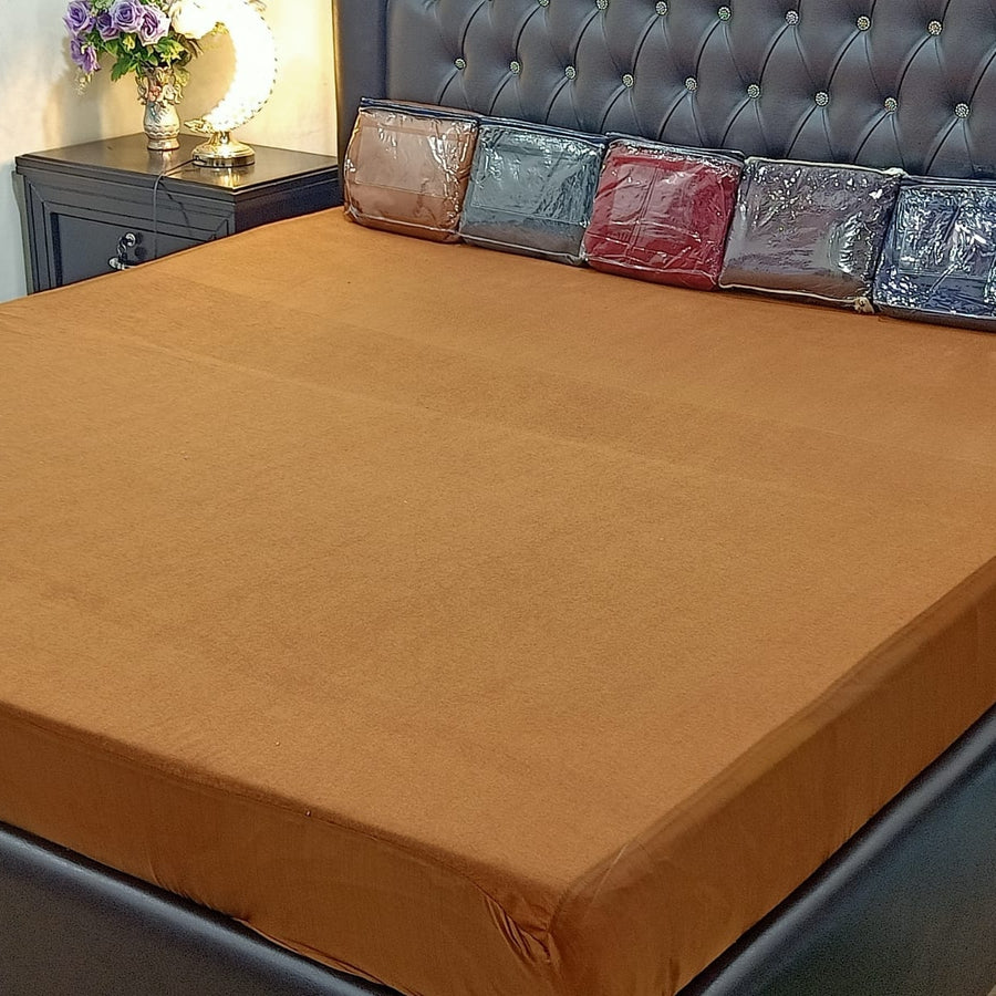 Terry cotton waterproof mattress protector fitted on a bed