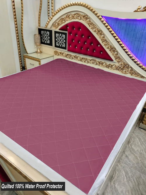 Quilted mattress cover on bed