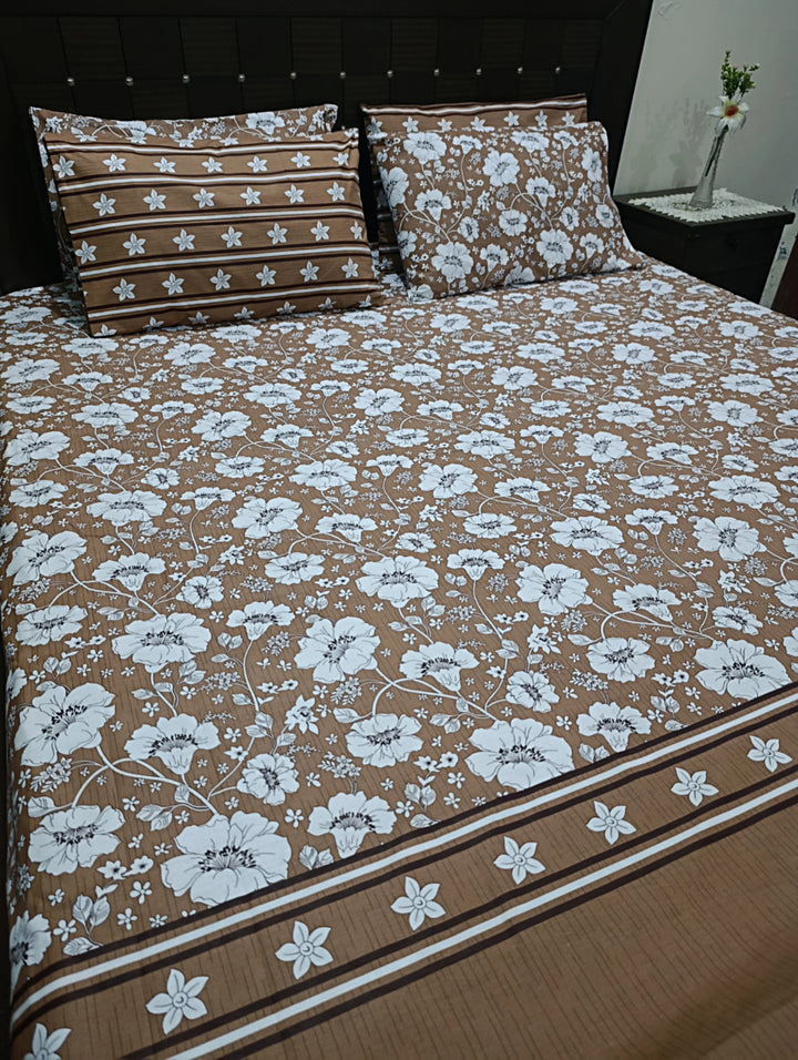 Brown floral bed linens with white flowers